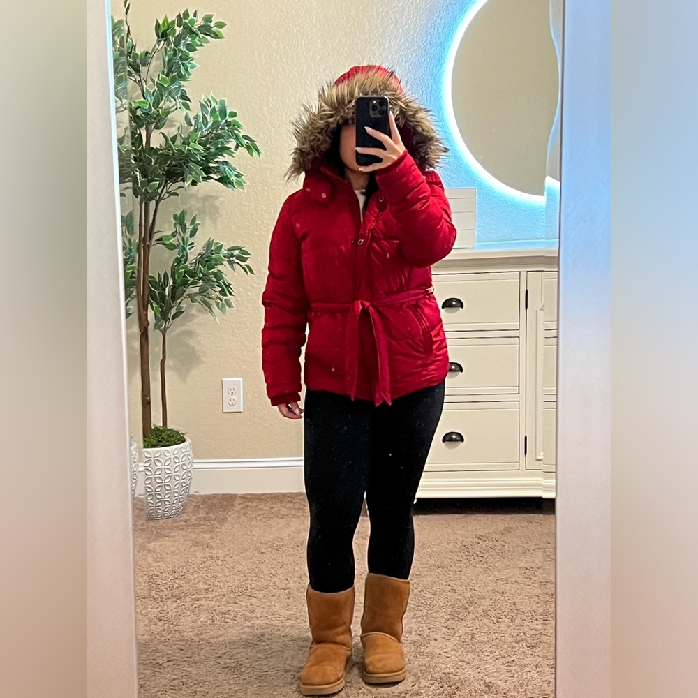 Red puffer jack with faux fur trim on the hood.